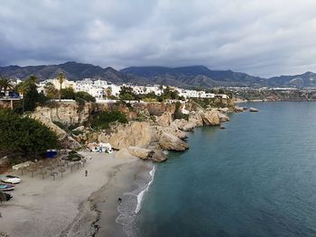 High angle view of townscape by sea against sky