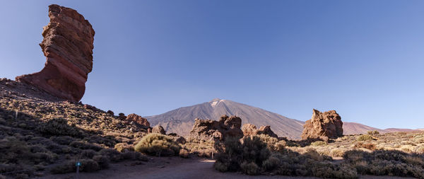 Scenic view of mountains against clear blue sky