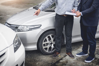 Low section of people standing on car