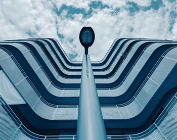 Low angle view of metallic railing against sky in city