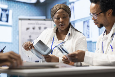 Female doctor examining patient in office
