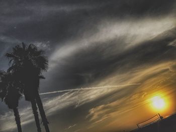 Low angle view of silhouette palm trees against sky during sunset