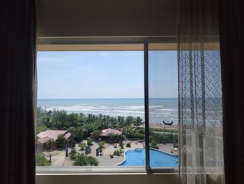 Scenic view of sea seen through window