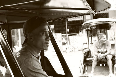 High angle view of man sitting on street