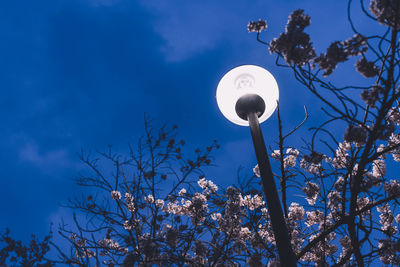 Low angle view of street light against blue sky