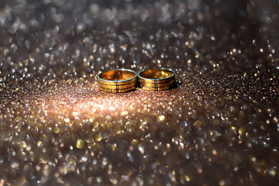 Close-up of wedding rings on table