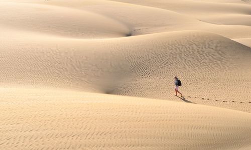 High angle view of woman walking on desert