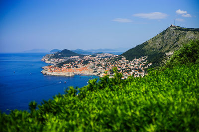 Scenic view of sea and buildings against sky