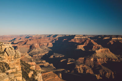 Aerial view of rock formations against clear blue sky