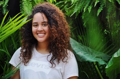 Portrait of smiling woman against plants