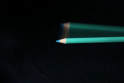 High angle view of pencil on table against black background