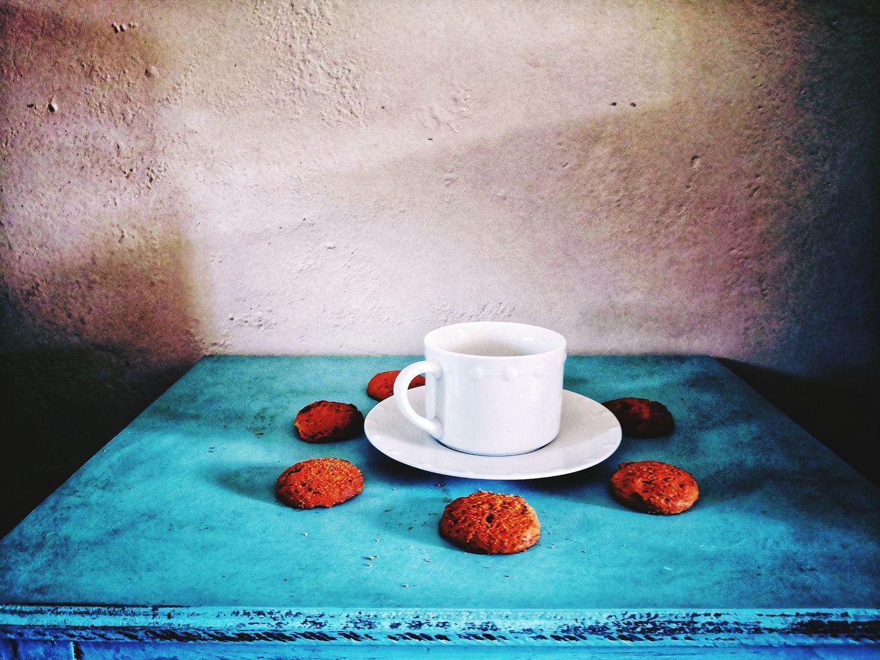 HIGH ANGLE VIEW OF COFFEE CUP ON TABLE WITH SPOON