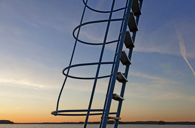 Ladder to jumping tower in sunset