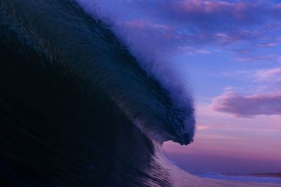 Powerful wave breaking on the shore of hossegor, france. sunset colors