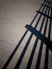 High angle view of shadow on footpath