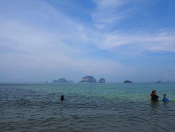 People on beach against sky