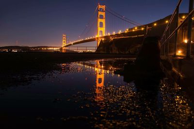 Low angle view of suspension bridge at night