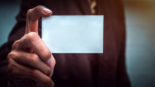 Close-up of person holding paper