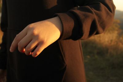 Midsection of woman standing outdoors