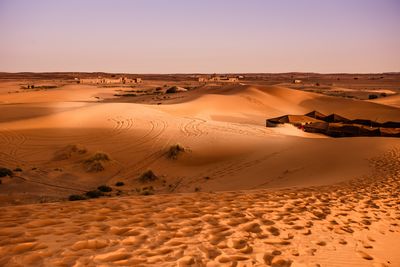 Scenic view of desert against sky during sunset