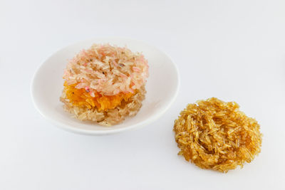 High angle view of food in plate against white background