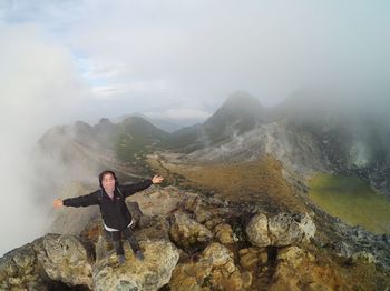 Full length of man on rock in mountains
