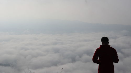 Rear view of man standing against sky