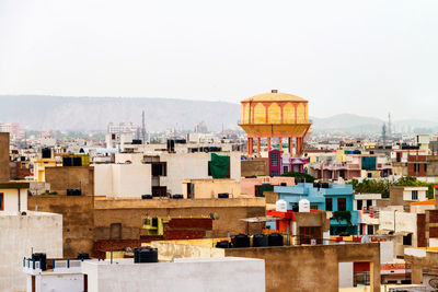 Buildings in city against clear sky