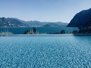 Scenic view of lake against clear blue sky