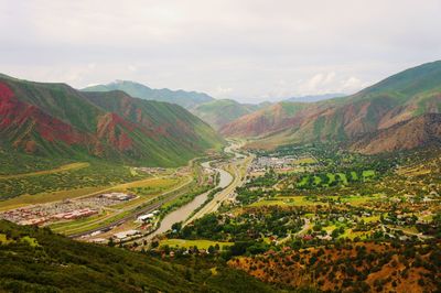 Scenic view of mountain with trees and houses