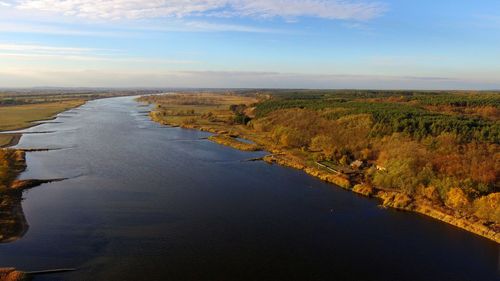 Scenic view of river amidst landscape against sky