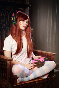 Young woman sitting on sofa at home