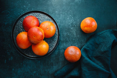 High angle view of orange fruits in bowl on table