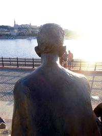 Man standing on water against sky