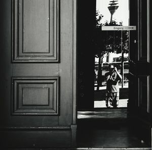 Full length of woman walking by building