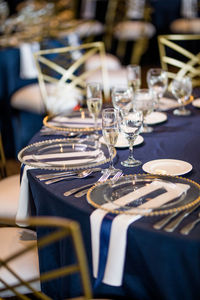 Champagne flutes and plates on table in restaurant