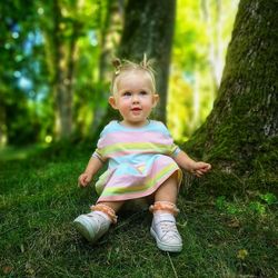 Full length of cute girl standing in forest