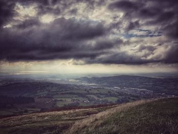 Scenic view of landscape against cloudy sky