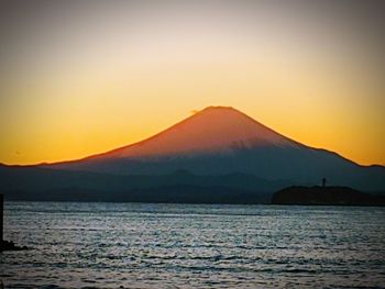 Scenic view of sea against clear sky during sunset