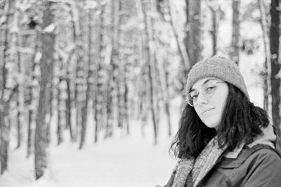 Portrait of woman in forest during winter