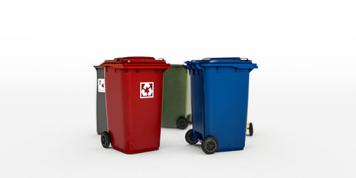 Red garbage can against white background