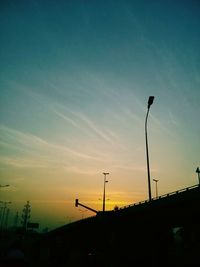 Low angle view of street light against sky at sunset