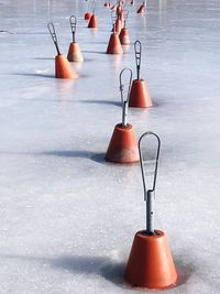 High angle view of buoys on frozen sea