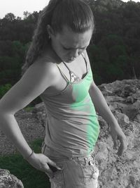 Girl with arms raised against trees