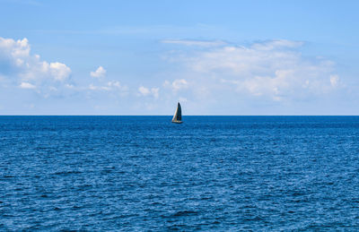 Sailboat on horizon, blue sea, summer, travel, vacation.