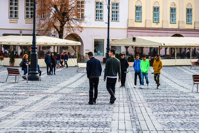 Group of people walking on city street