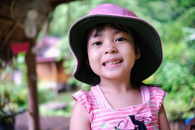 Kid smiling felling proud pink hat at nature outdoor