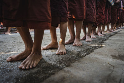 Low section of people standing on street