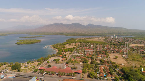 High angle view of townscape by sea against sky