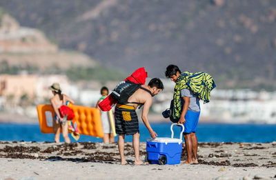 People with toy on beach